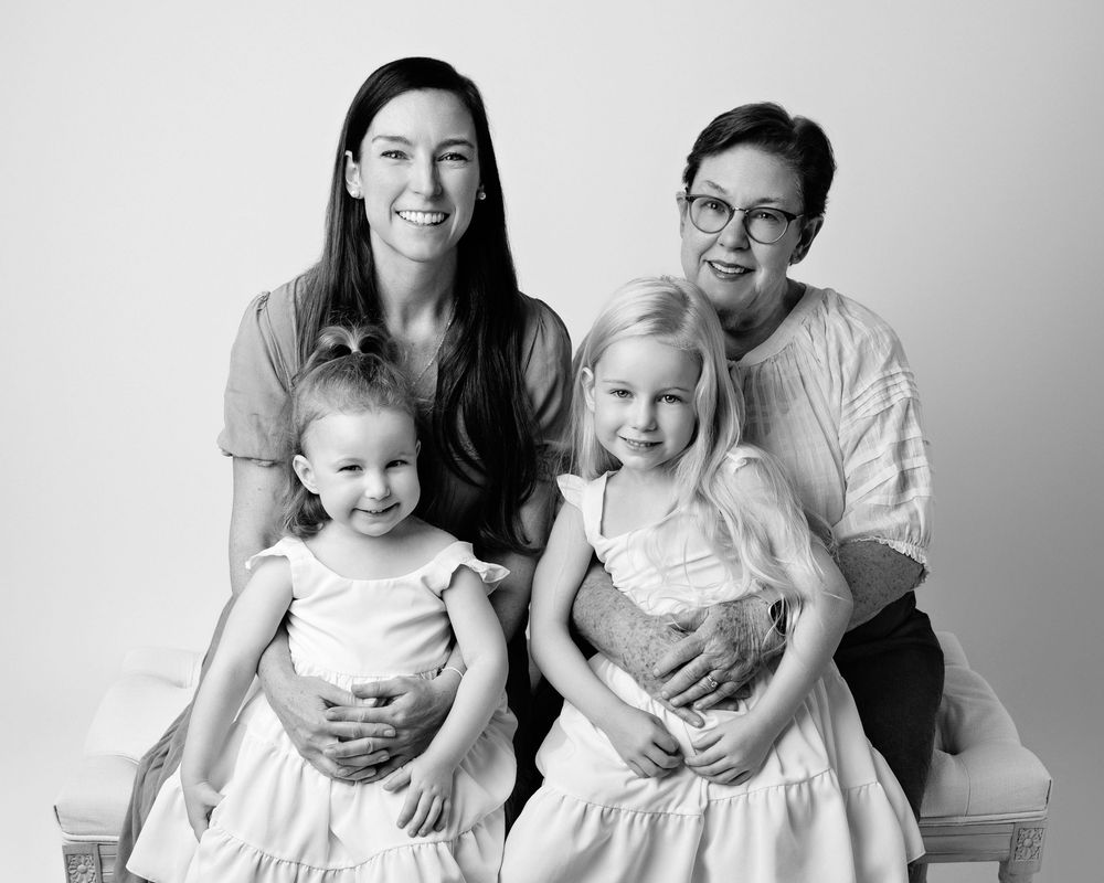 Black and white studio portraits showing a happy family moment with young children.