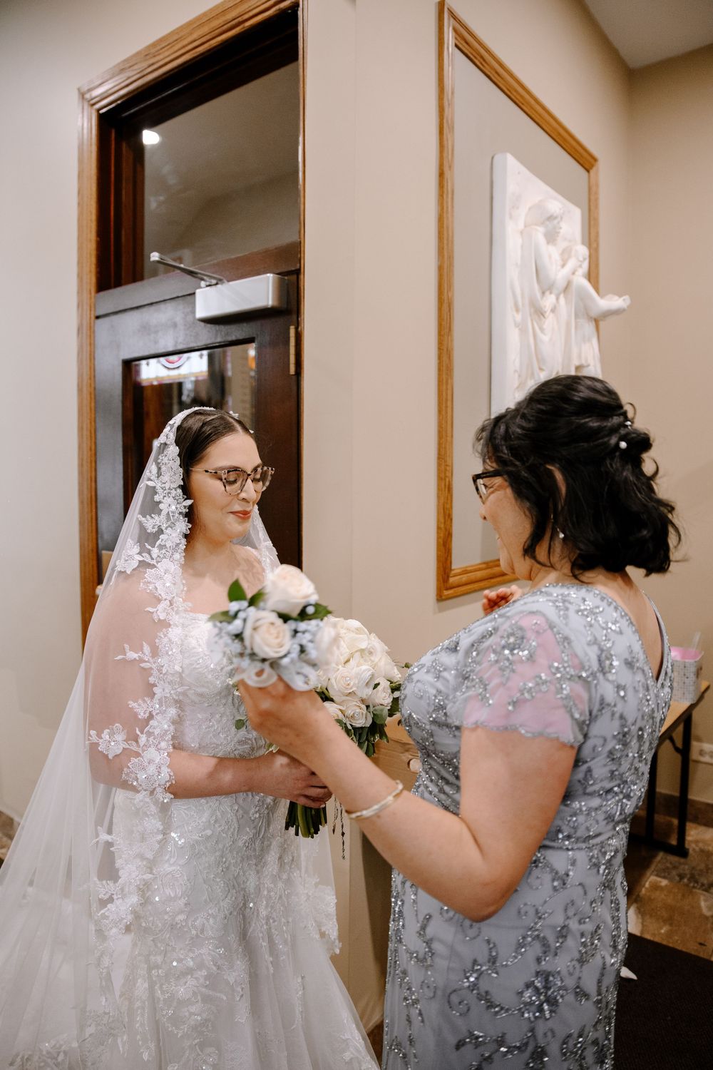 A sequence of images shows someone in a gray lace dress adjusting their delicate white wedding veil in a dressing room.