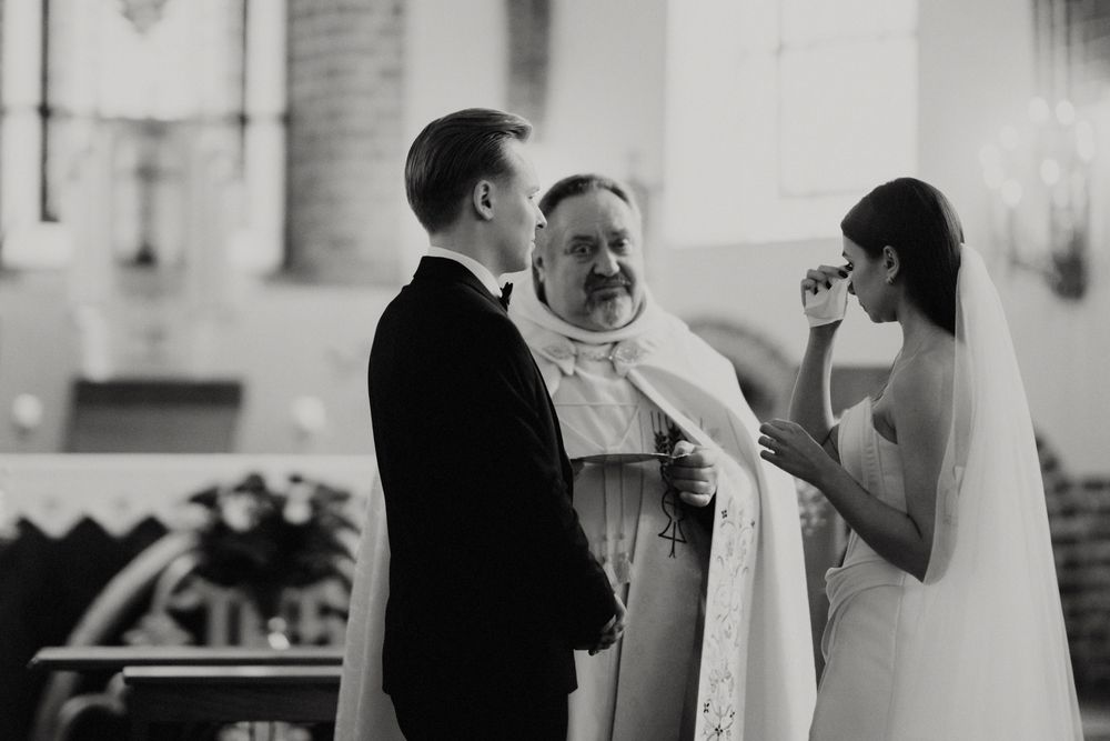 Candid moments captured during an indoor wedding ceremony in a bright church setting.