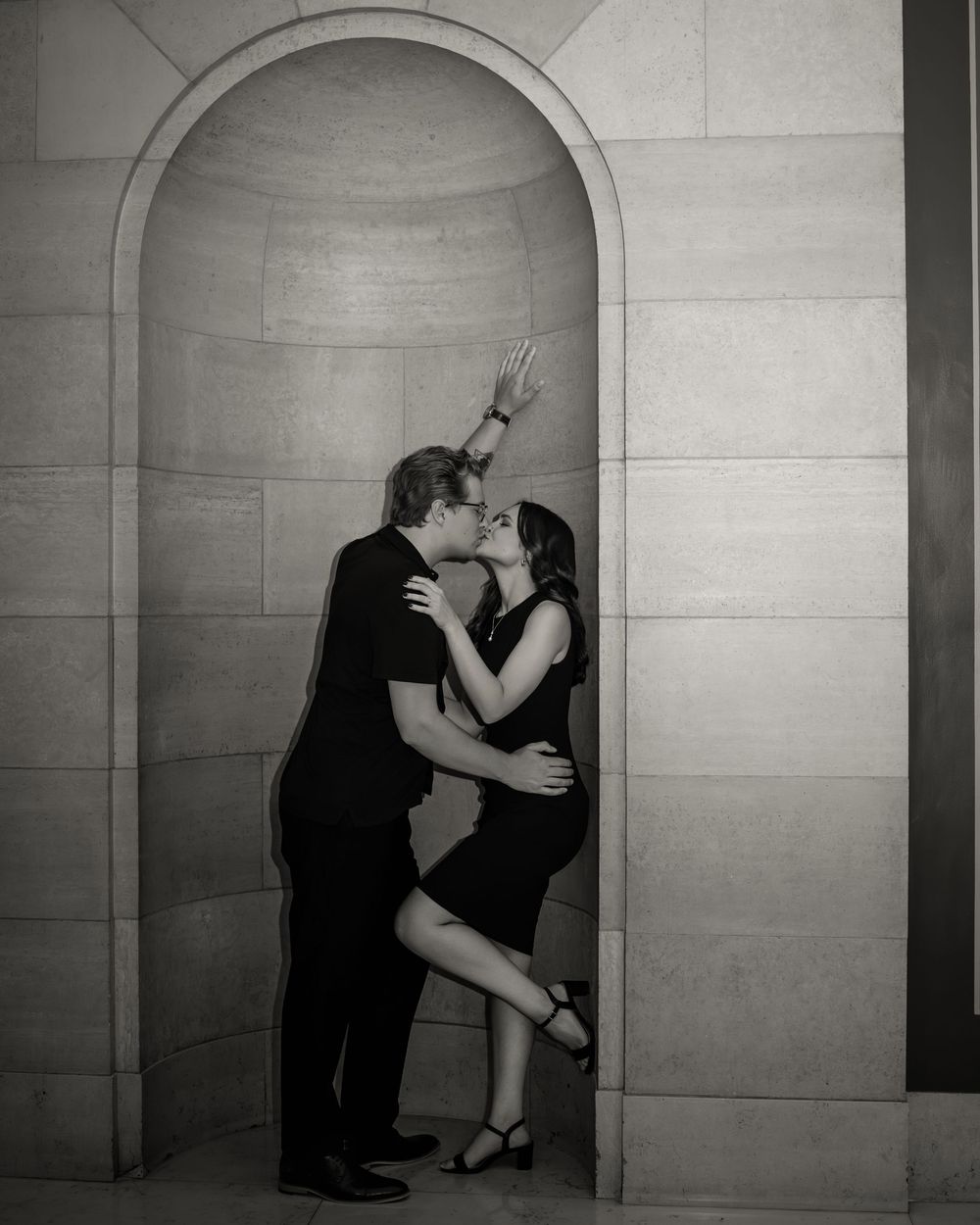 A romantic dance sequence shown in five progressive black and white photographs against a stone wall.