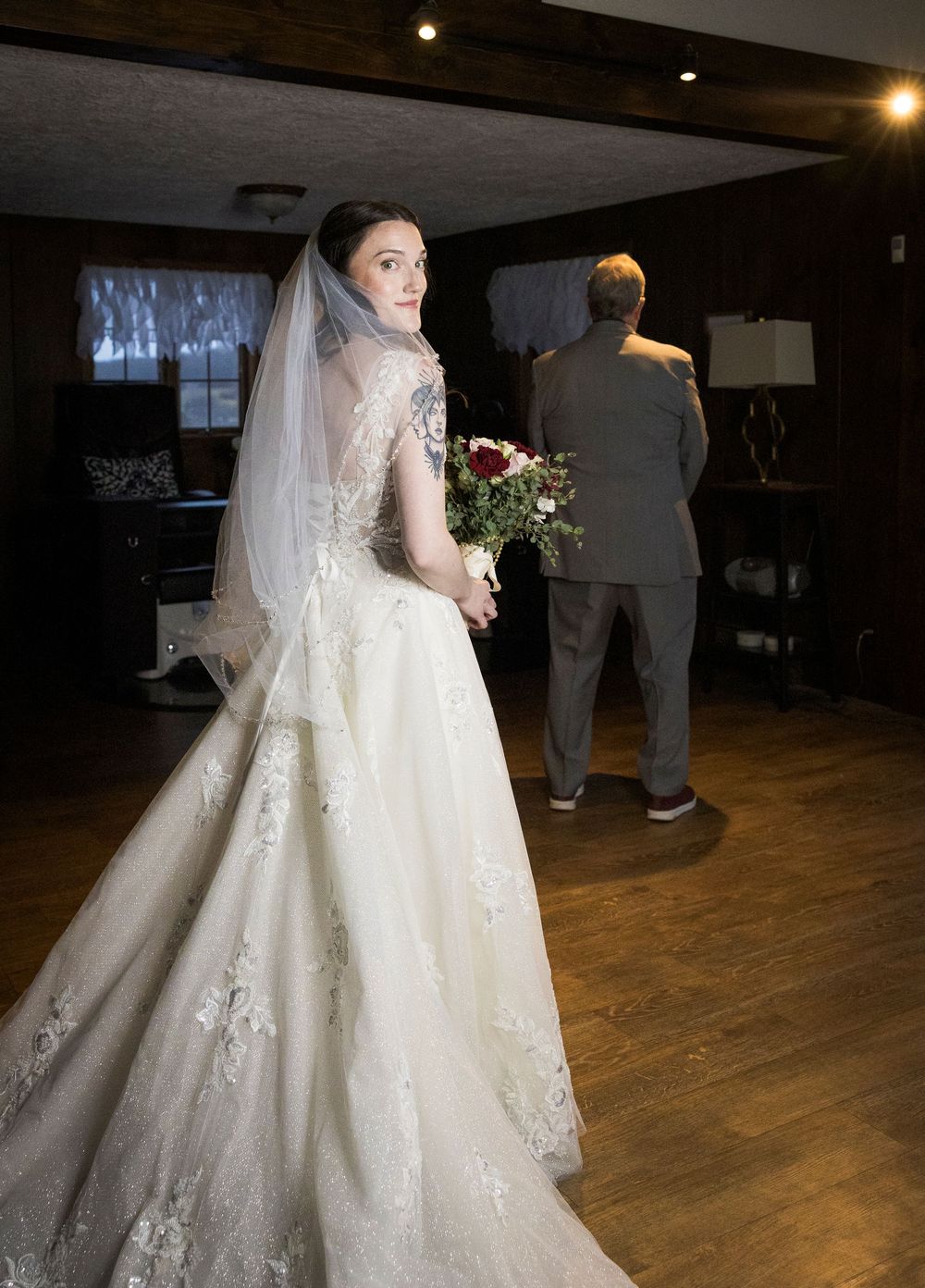 A series of wedding photos showing a bride in a white lace gown with a flowing veil on a wooden dance floor.