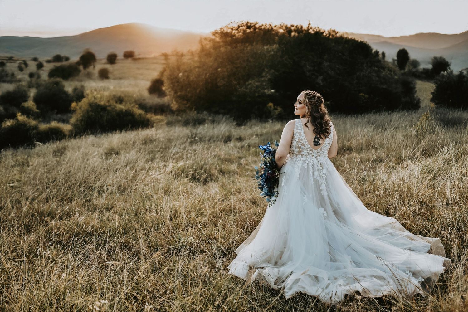 Golden hour bridal portrait of blonde bride in embroidered veil with vintage shoes in Corinth, Texas.