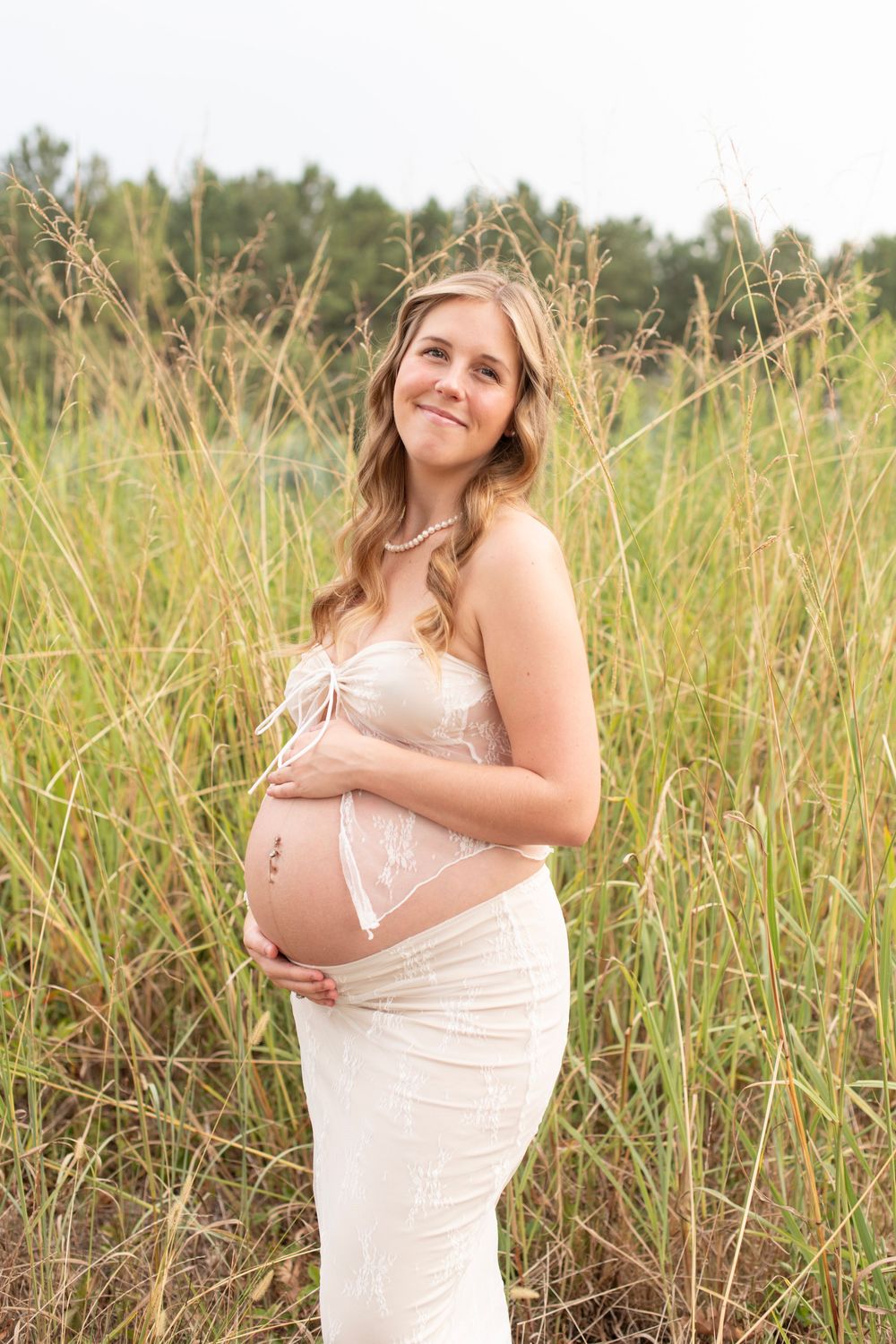 Maternity portrait in a wild grass field at Cedar Ridge Tree Farm in Gilbert, SC.