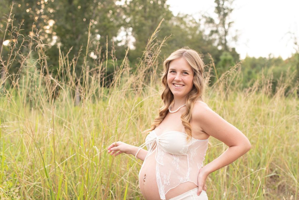 Maternity portrait in a wild grass field at Cedar Ridge Tree Farm in Gilbert, SC.