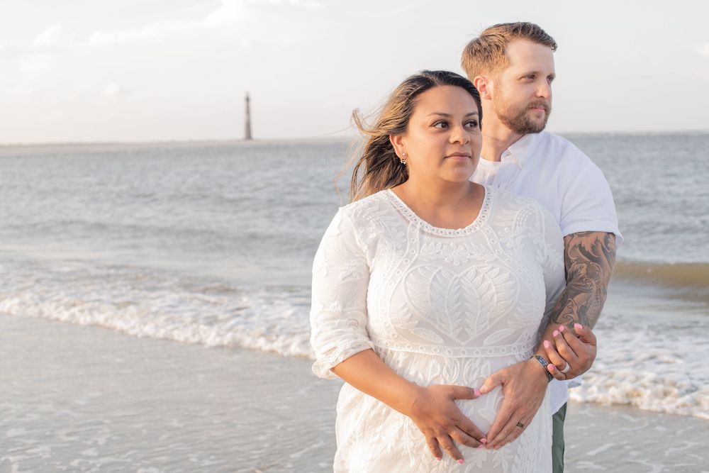 Couples poses at Morris Island by Folly Beach for maternity session.