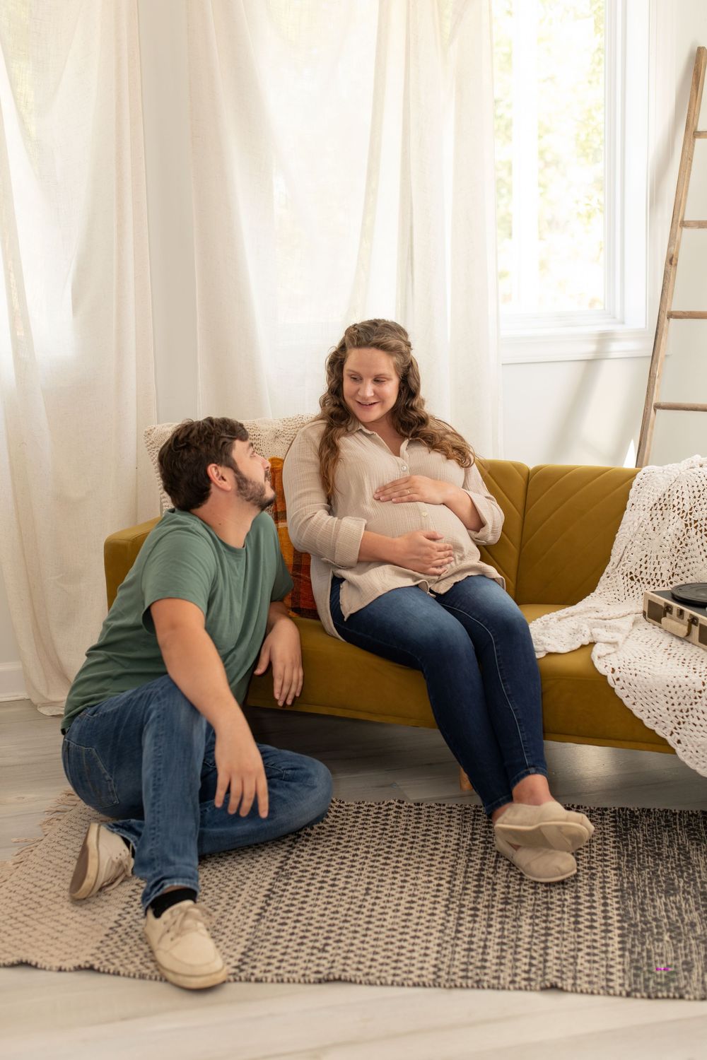 Couple poses during maternity session in studio at Joyride Social Studio in Lexington, SC.