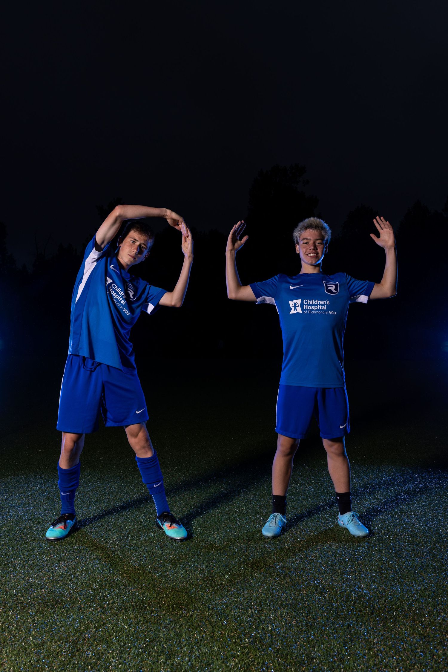 Athletes in blue uniforms demonstrate stretching positions against dark background.