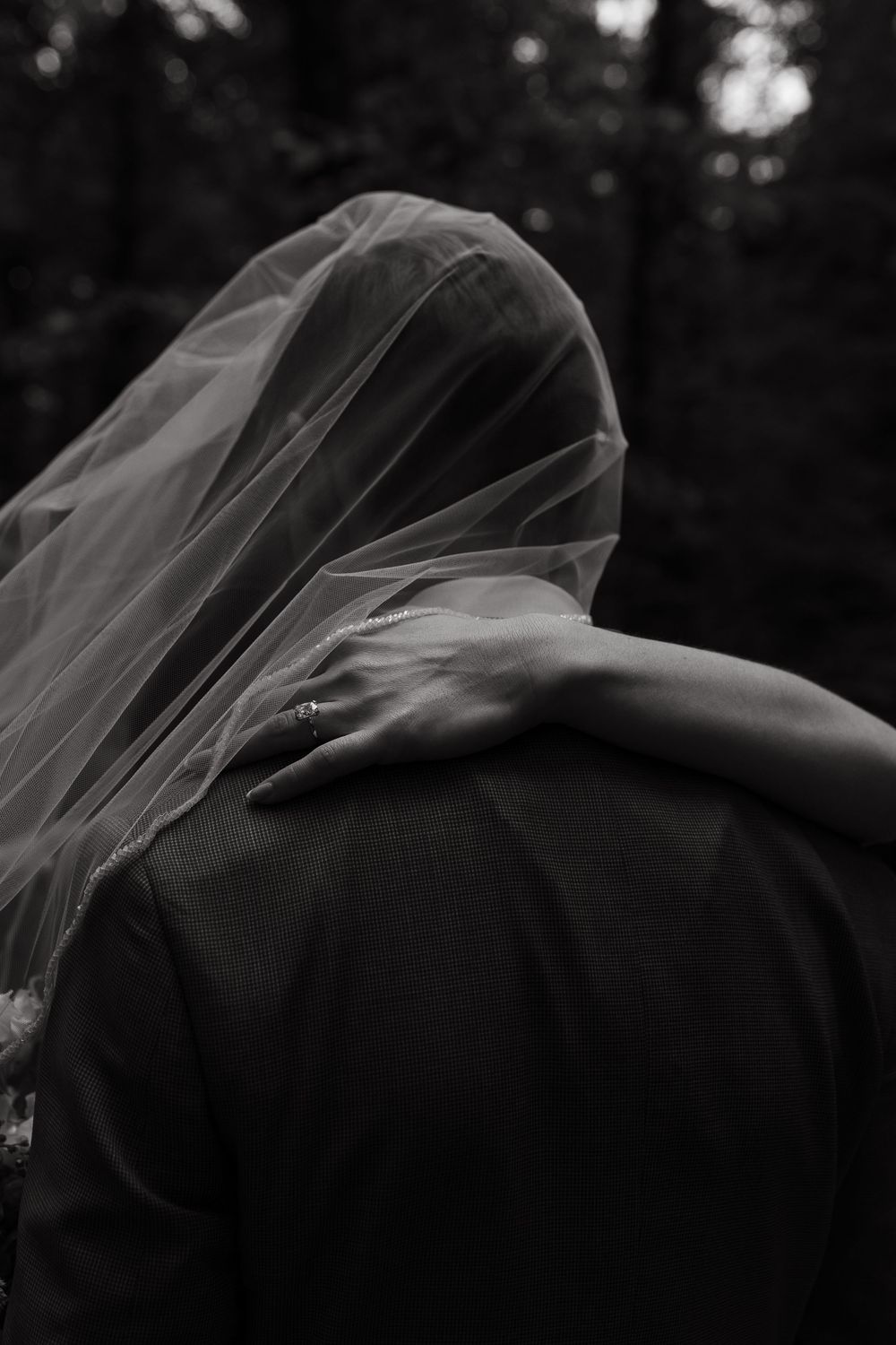 Dramatic black and white shot of a wedding veil flowing in the breeze.