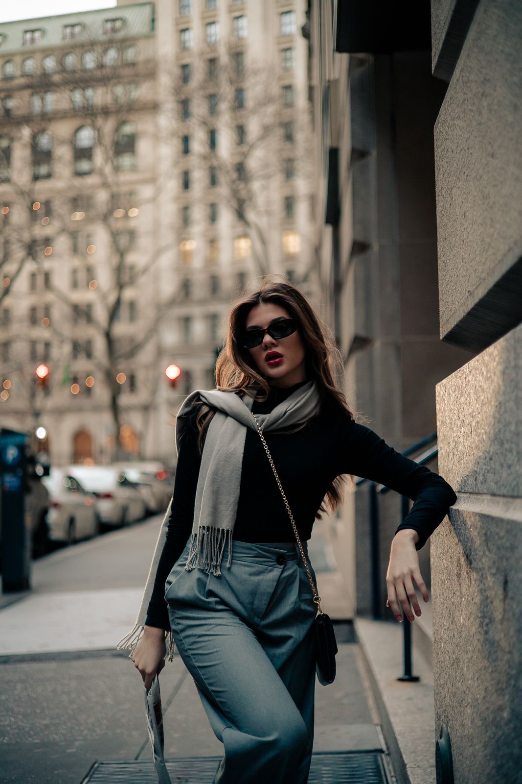 Editorial fashion shot of woman in chic coat tossing jacket, street style vibe in Miami, cinematic Mannyportraits photography