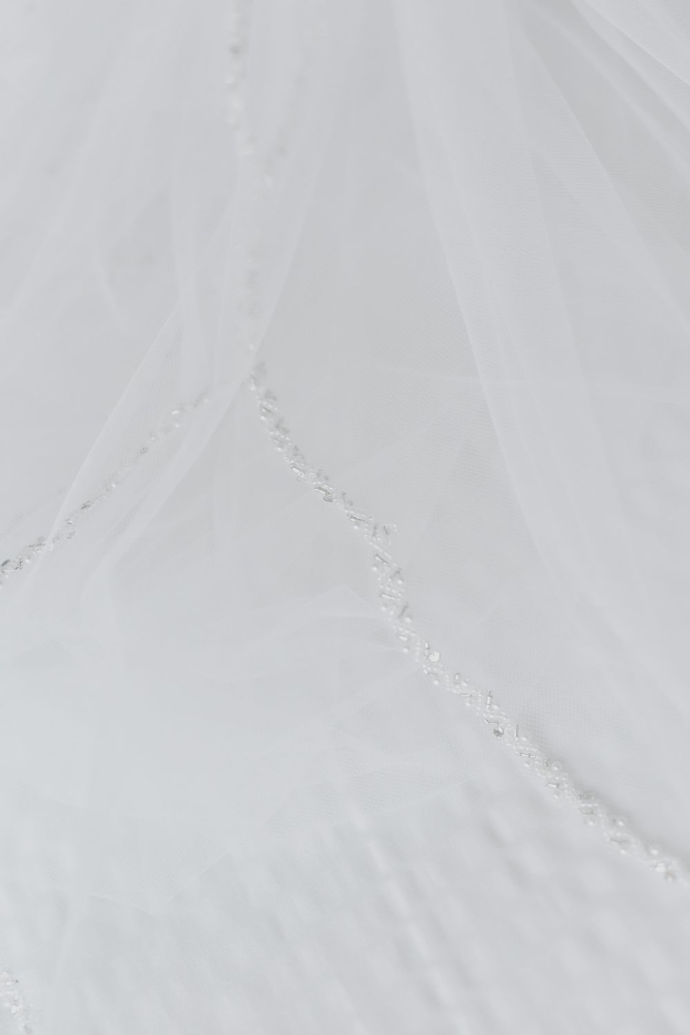 Snowy slope with delicate curving tracks revealing recent skiing activity on fresh powder surface.