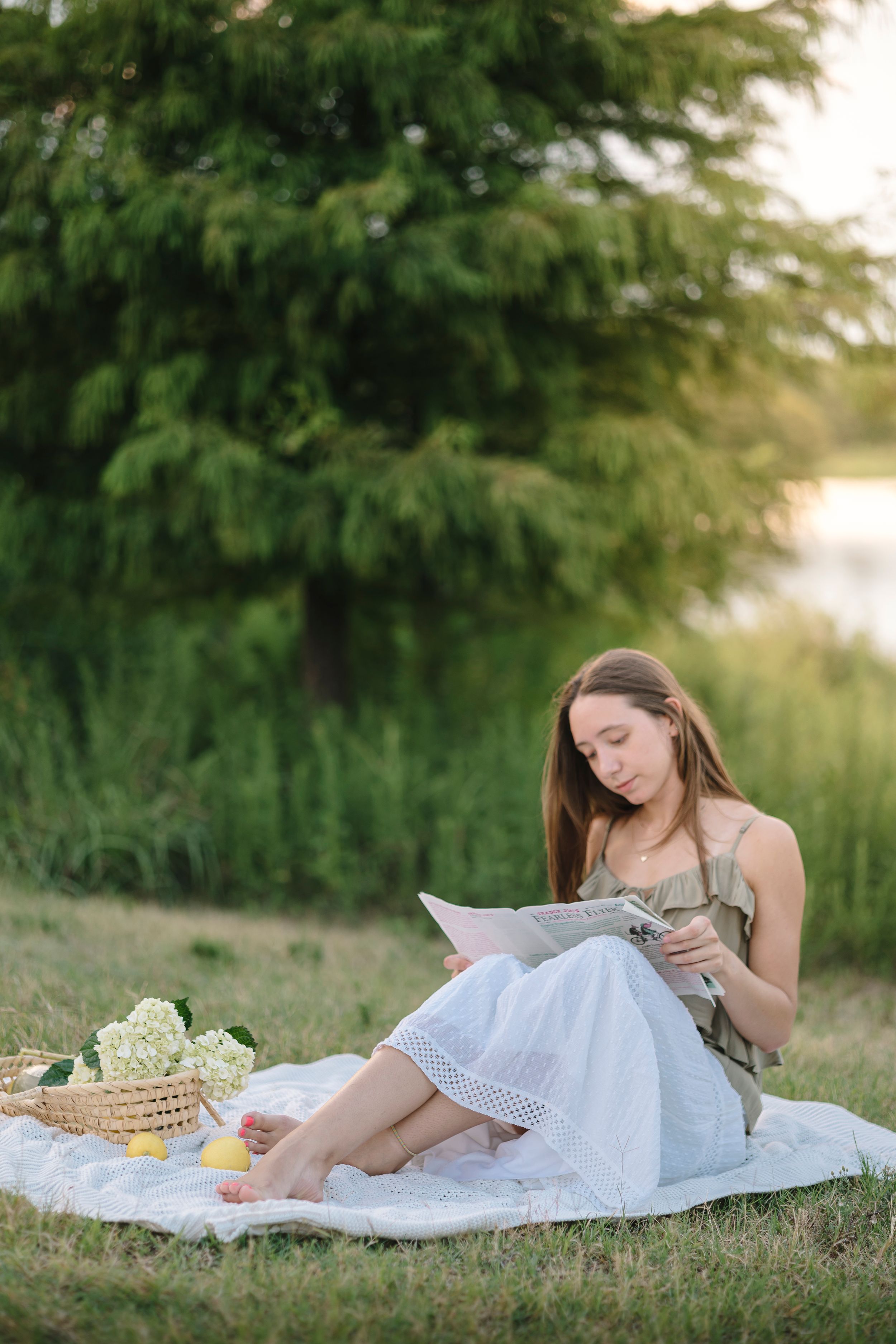 A serene outdoor portrait series featuring someone lying on a white blanket in a grassy field at golden hour.