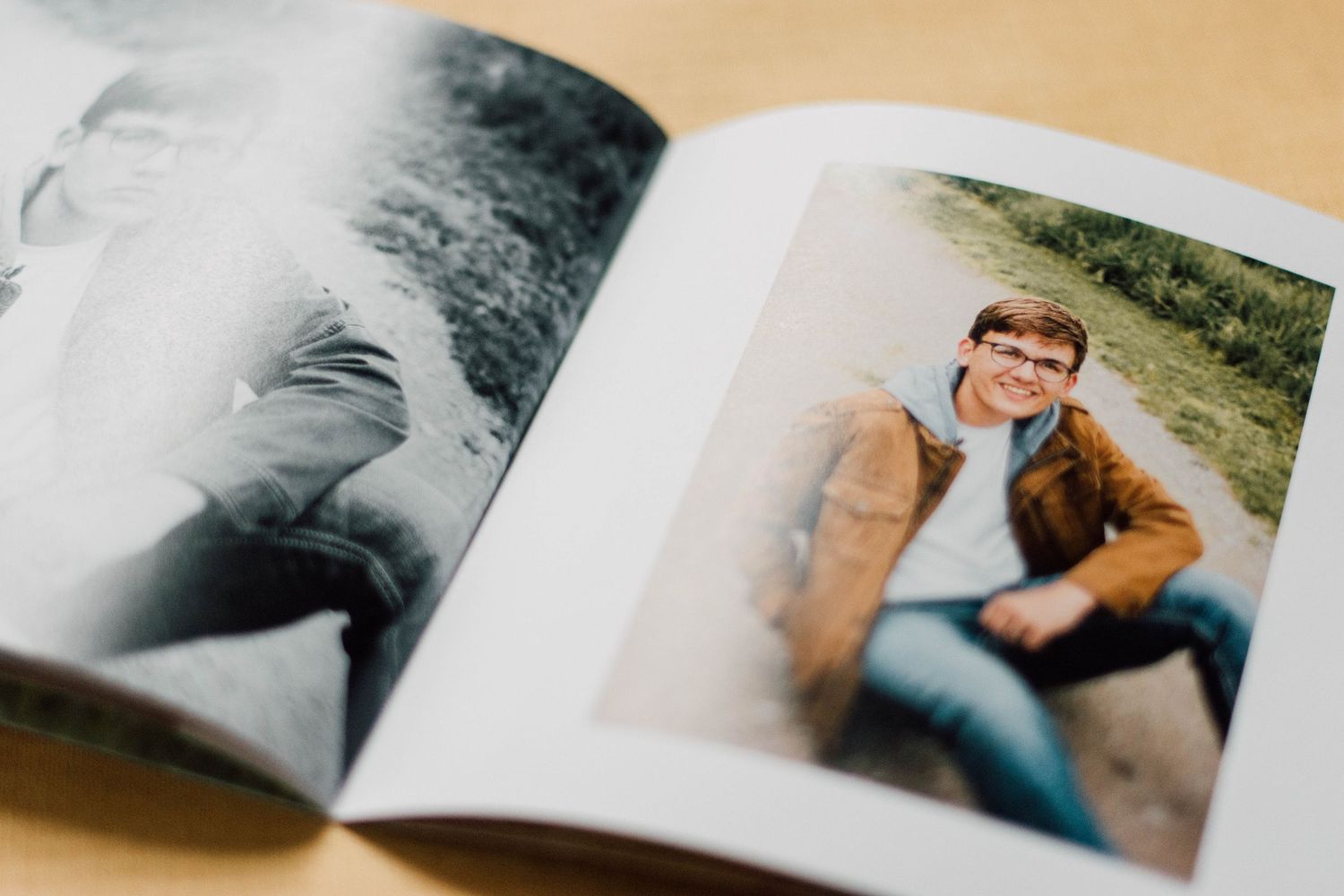 Open photo album displaying black and white portrait photographs across spread pages.