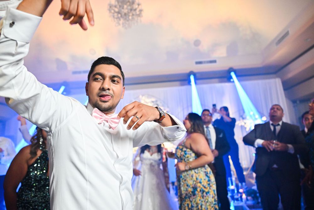 Wedding guest dancing enthusiastically on the dance floor during reception celebration.