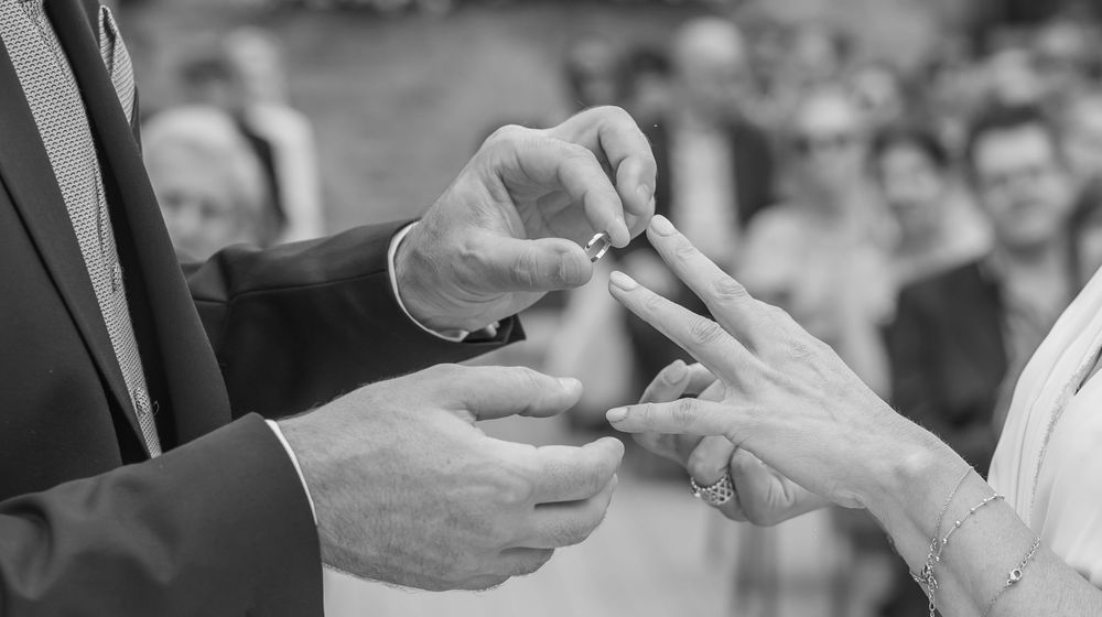 Black and white photo sequence showing hands exchanging business cards in a formal greeting gesture.