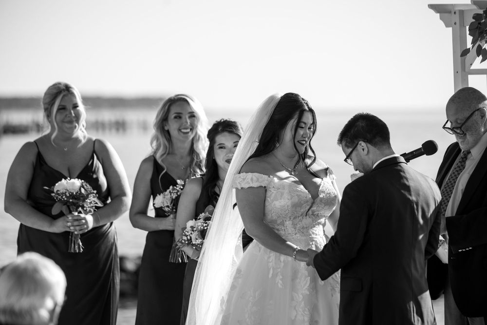 Wedding ceremony candid moments captured in black and white by the ocean.