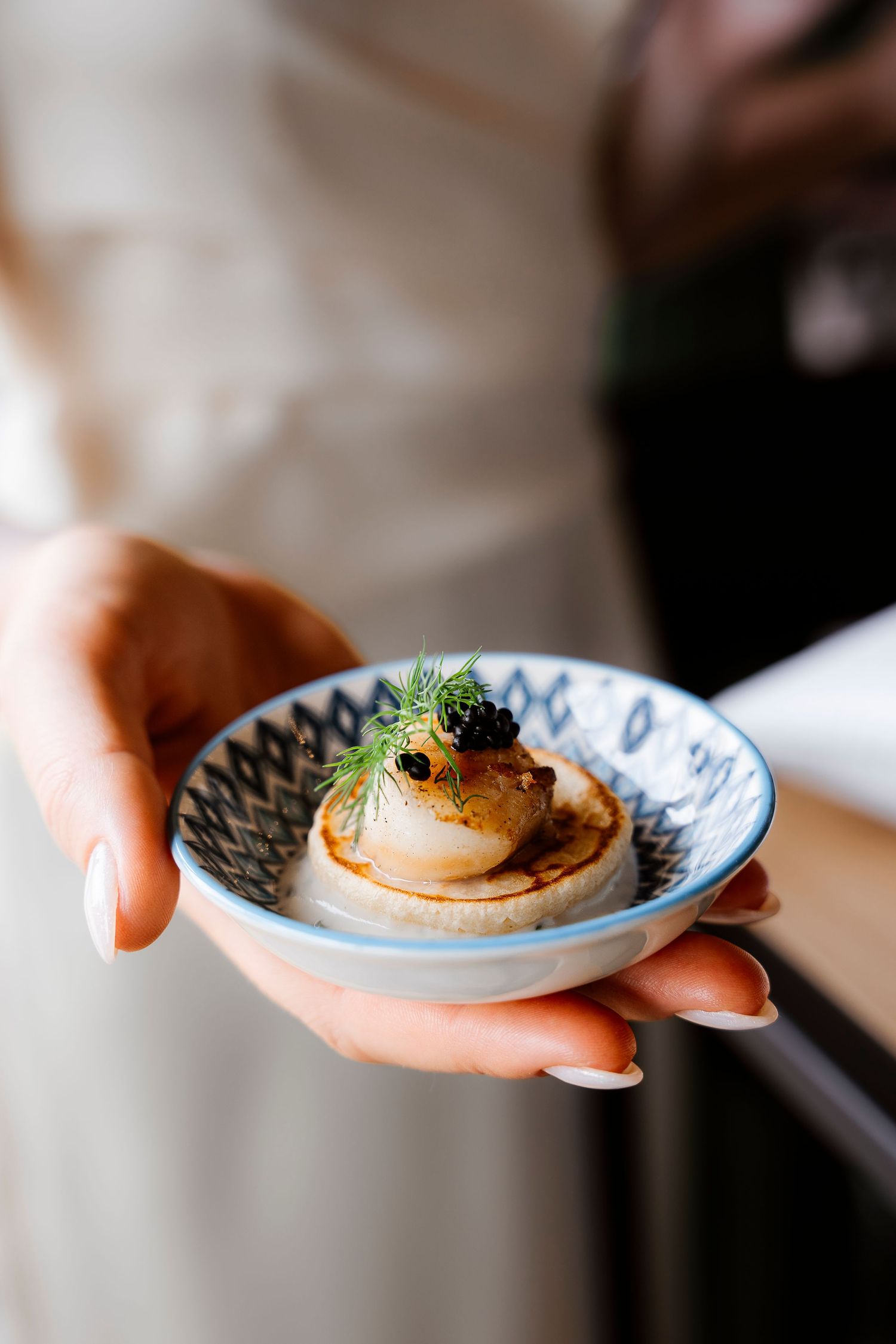 Elegant appetizer with garnish served on decorative blue and white porcelain plate.