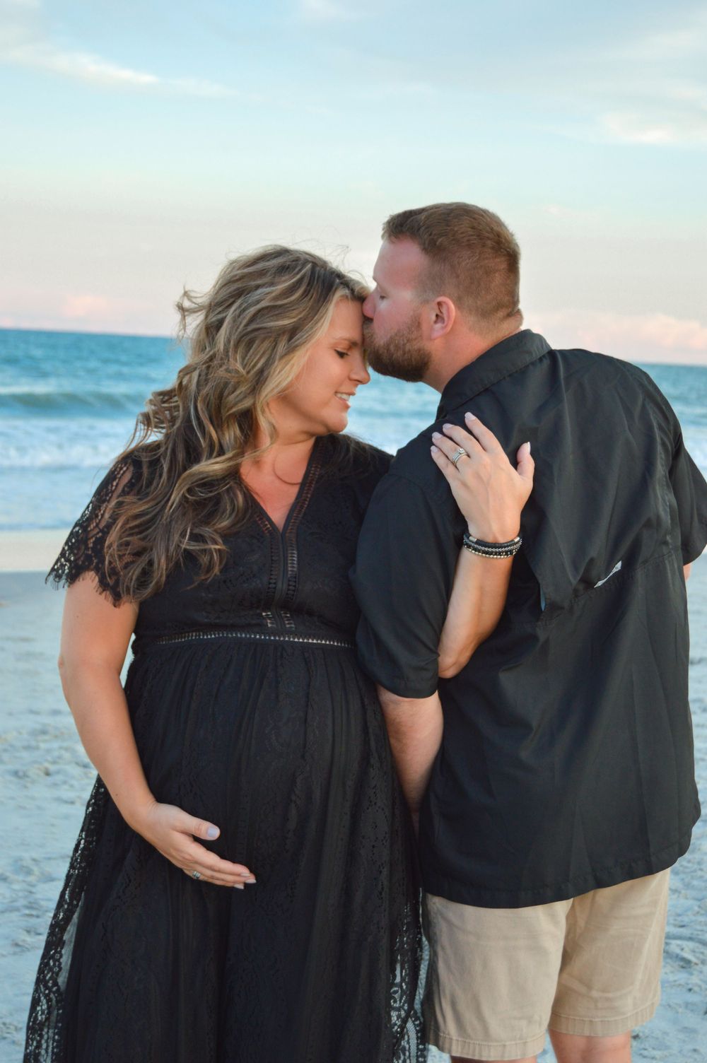 couple posed with each other on the beach for a photo session