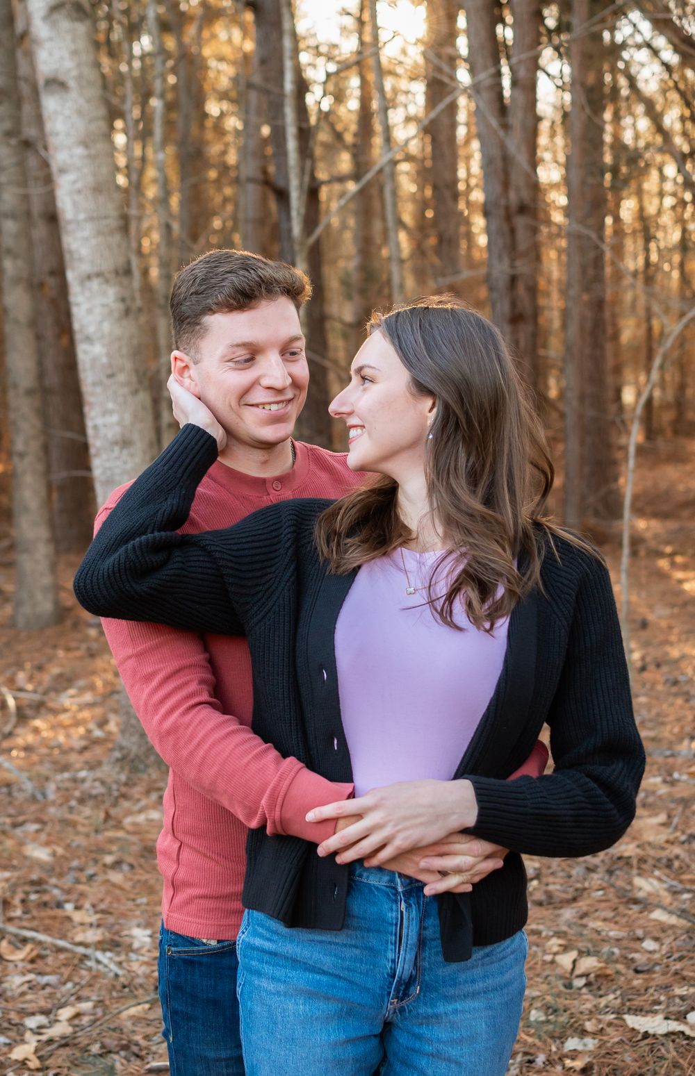 couple posed in the woods for a couples photo session