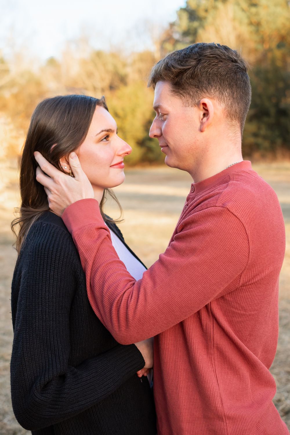 couple posed in a field for a couples photo session