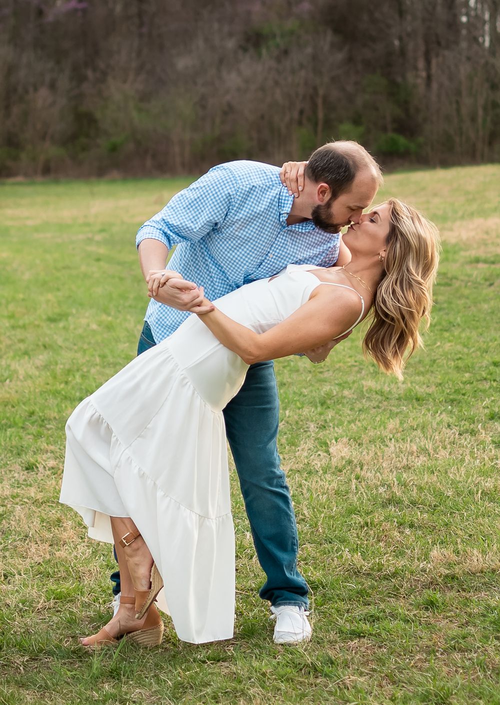 couple posed in a field for a couples photo session