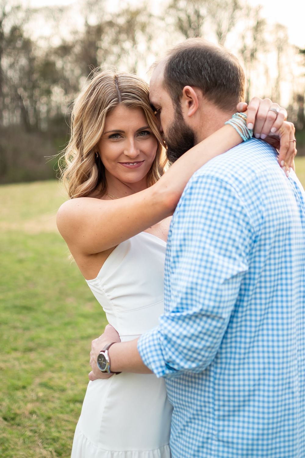 couple posed in a field for a couples photo session
