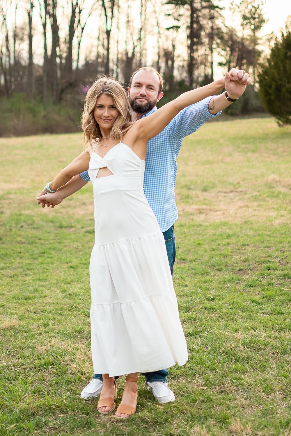 couple posed in a field for a couples photo session
