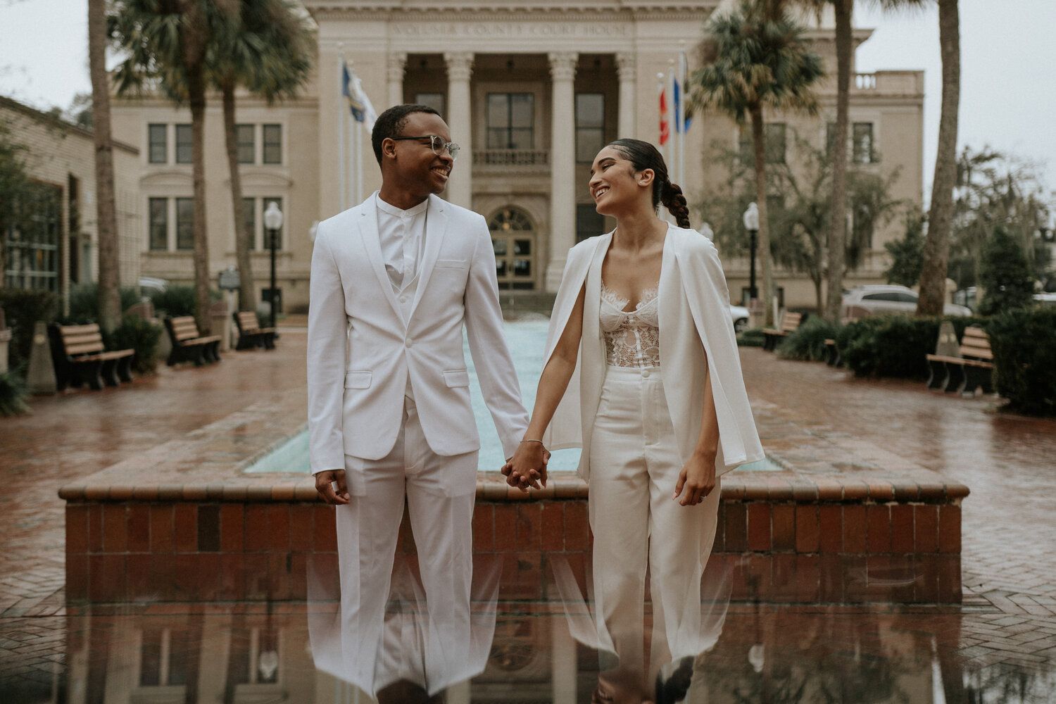 couple holding hands looking at each other