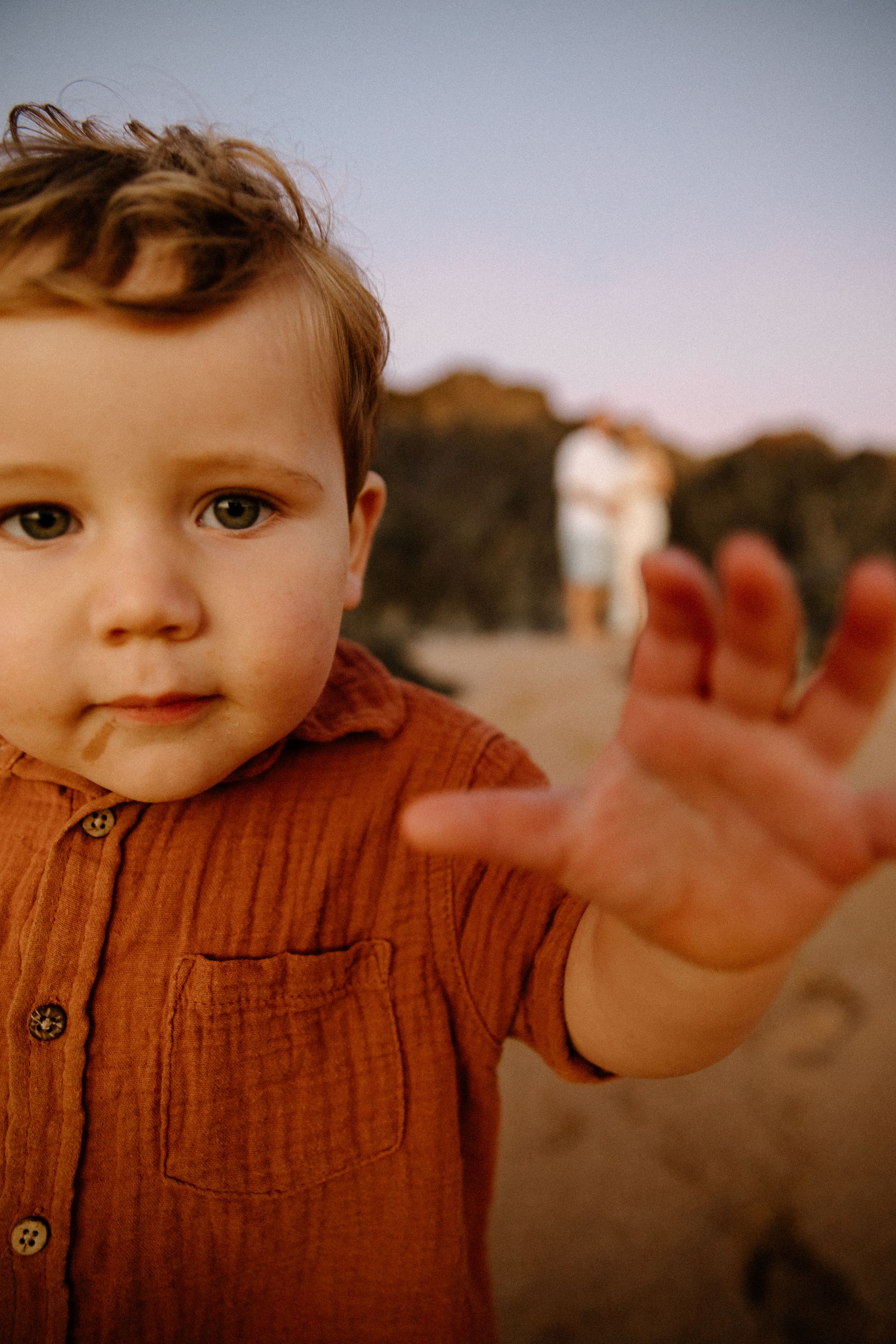 A child runs towards the camera during a family maternity session on the beach at sunrise in Point Samson, WA
