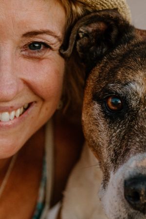A close up pet portrait of a dog and its owner, on the beach in Cossack, WA