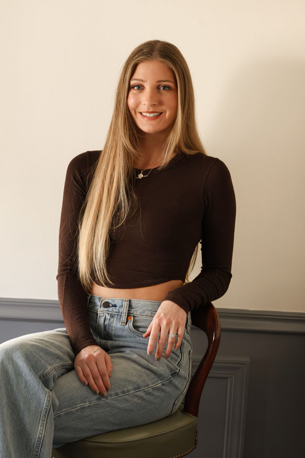 Casual portrait series showing relaxed poses in denim and black top against neutral backdrop.