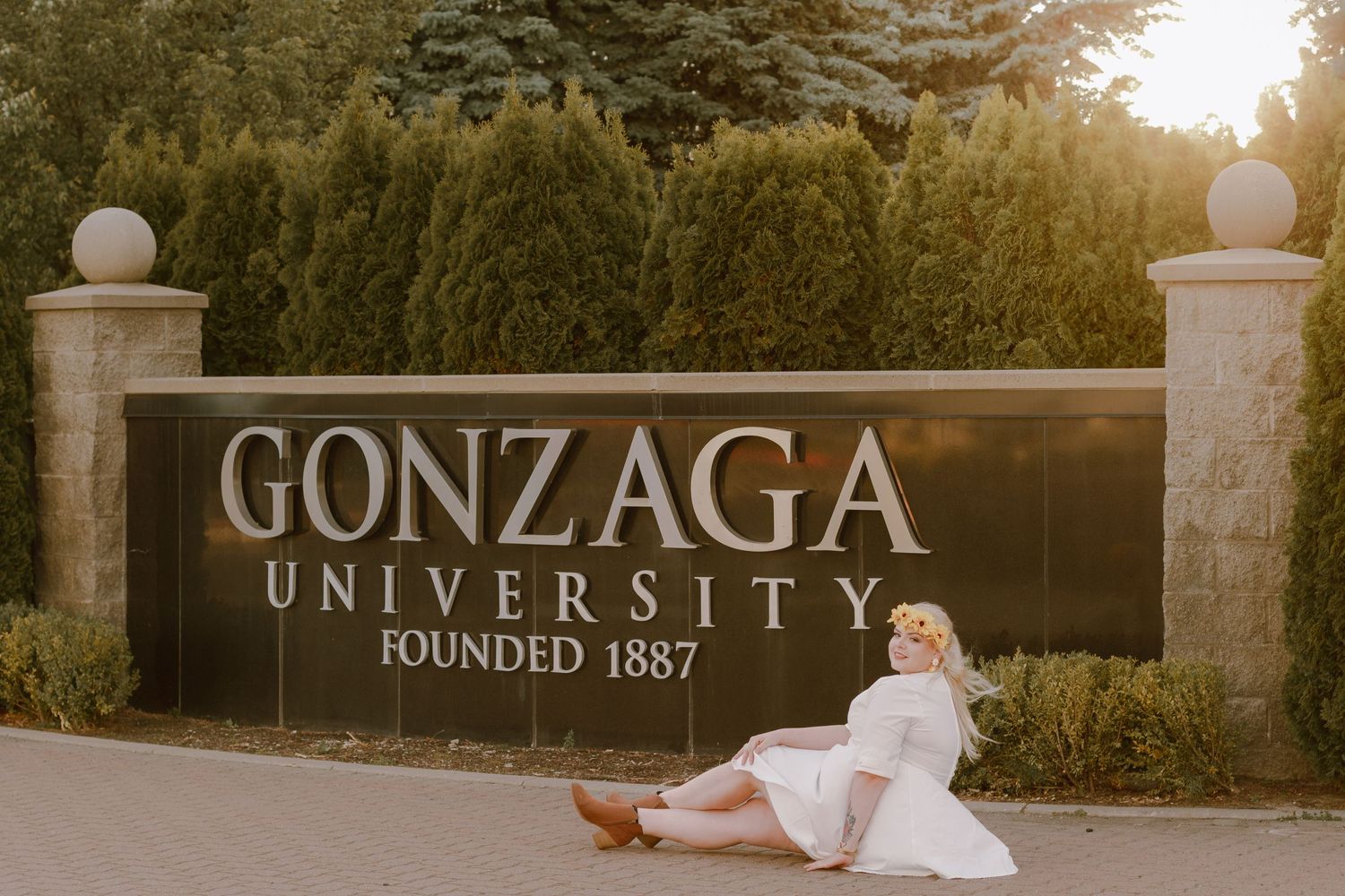 Criminology Major College Senior Portrait Session posing at Gonzaga University sign in downtown Spokane, Washington.