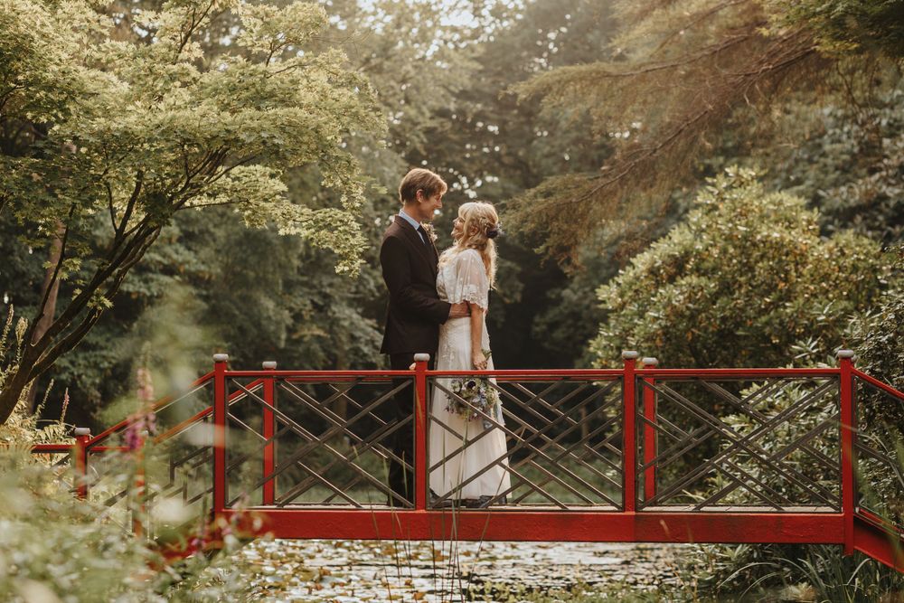 Bride and groom walking through a garden – wedding photography by Luis Gomes in Hertfordshire