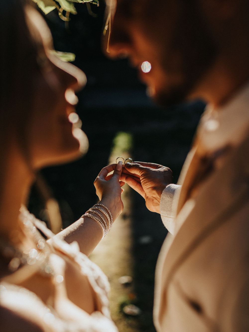 room placing ring on bride during golden hour – wedding photography by Luis Gomes in London