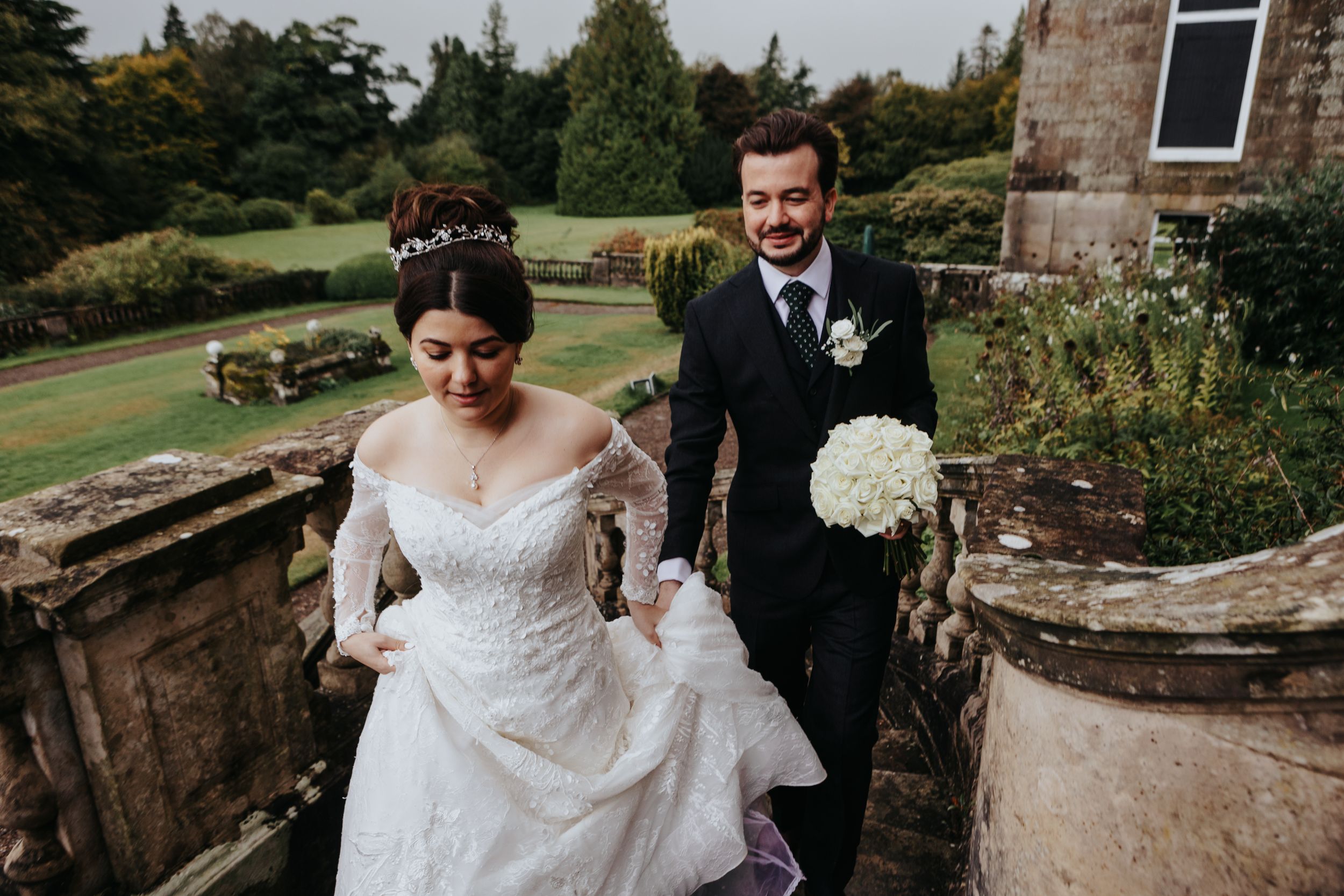 Bride and groom walking through countryside garden – wedding photographer Luis Gomes in Cambridgeshire