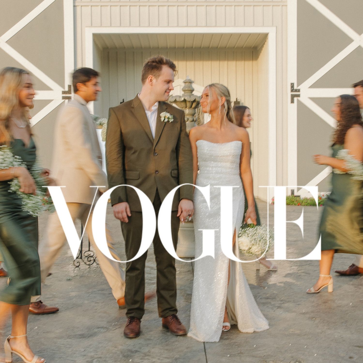 Wedding party exits venue with bride and groom in center under Vogue magazine branding.