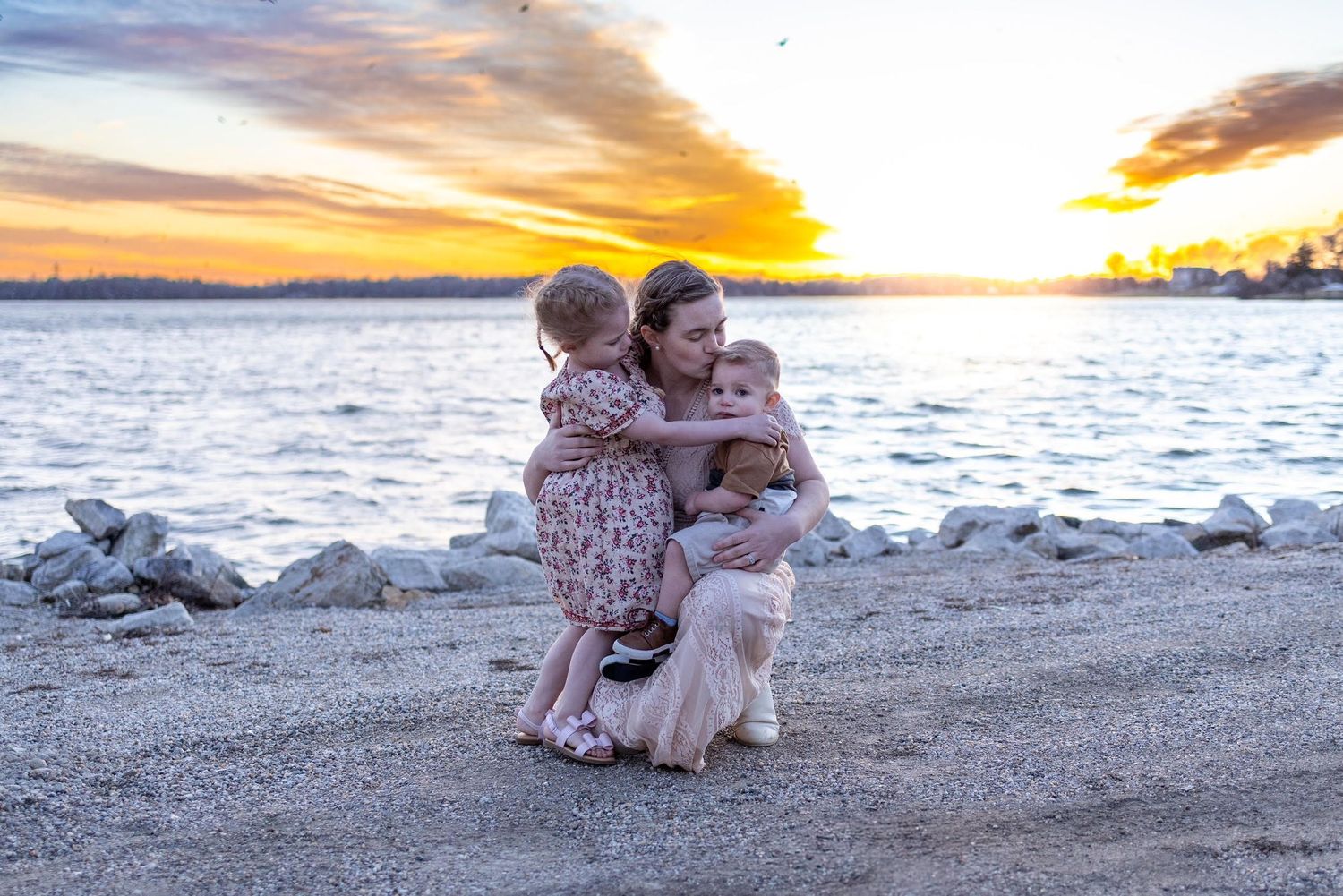 Springfield, IL family photographer snuggles with her two kids at sunset in Central, IL