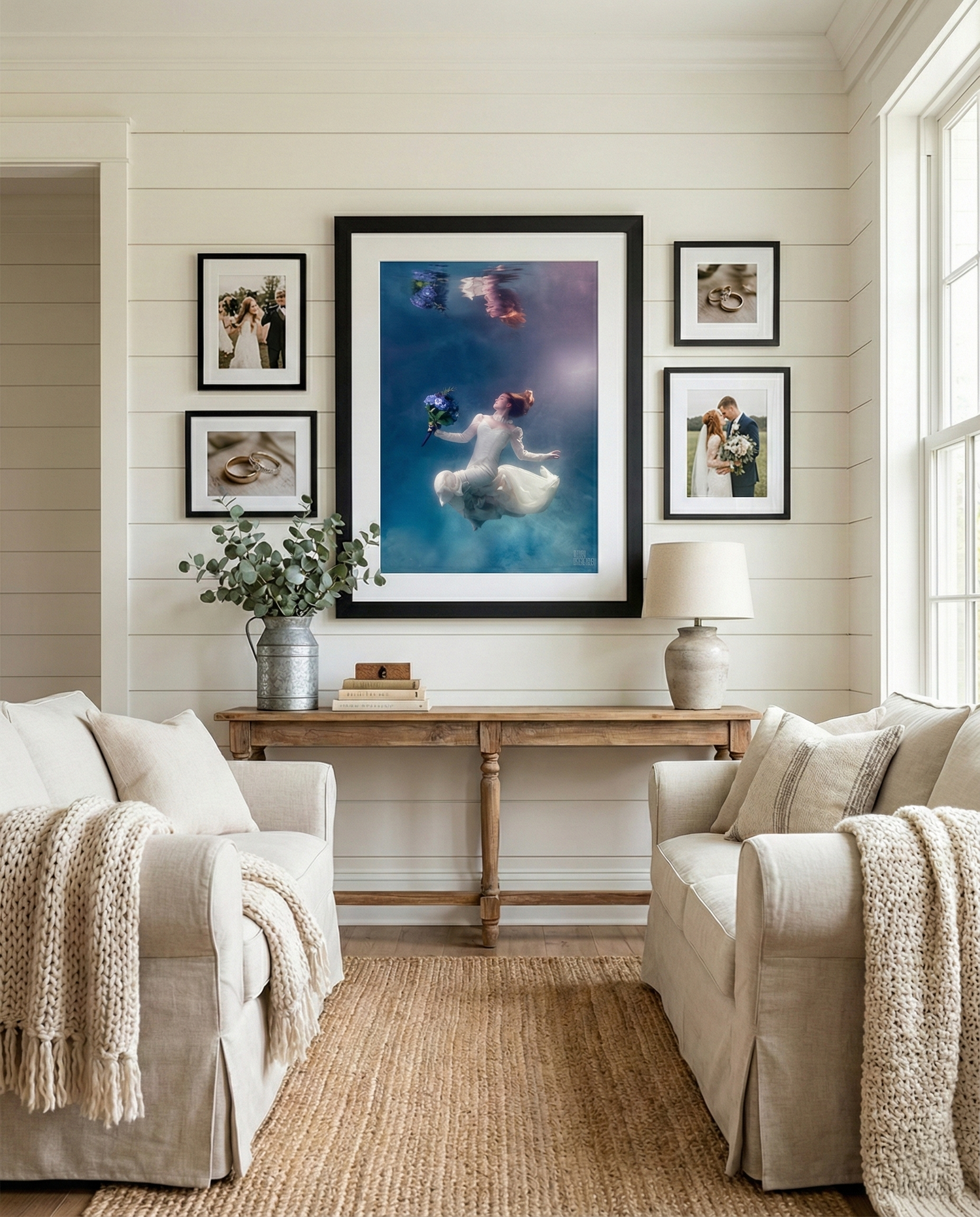 Elegant hotel lobby with warm lighting, plush furniture, and framed artwork displayed on beige walls.