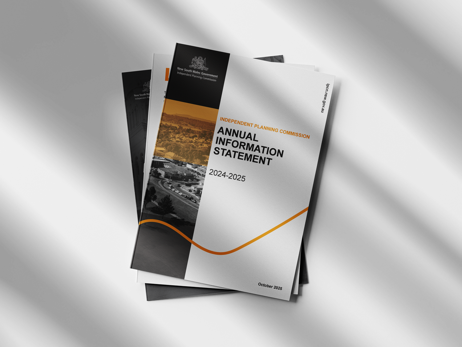 Professional business brochure mockups showing minimalist black and white designs with orange accents on a light background.