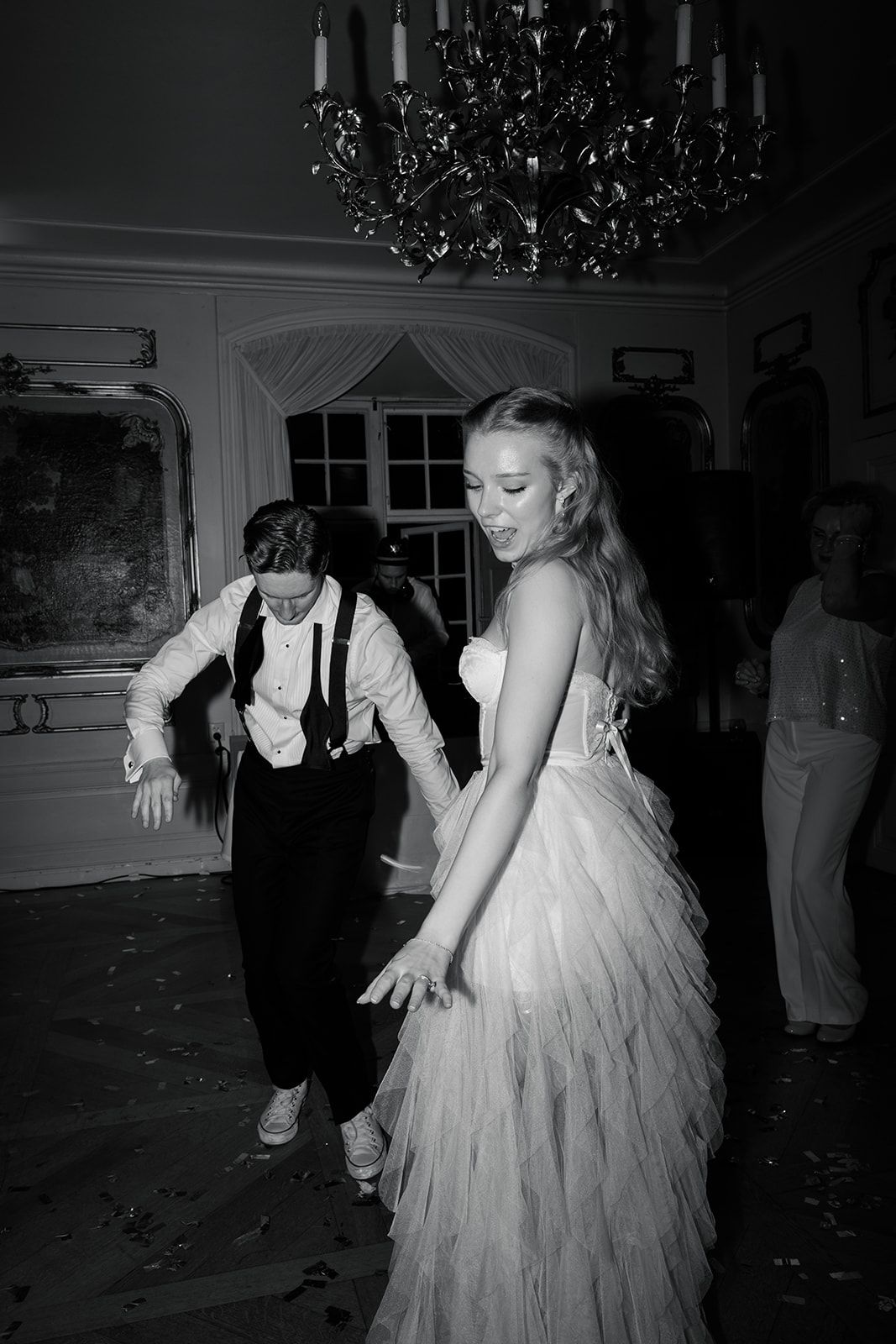 Young dancers in white dresses twirl and spin gracefully across a dance floor during a performance.