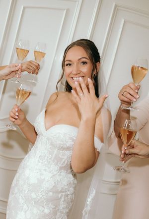 Wedding celebration scene with champagne glasses and elegant white lace details.