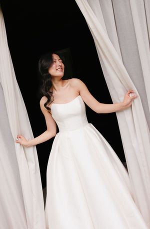 Artistic series of a person in white dress moving through flowing white curtains.