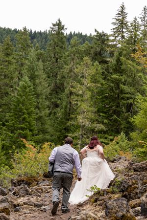 Bride and Groom hiking to their elopement in Oregon, Oregon Elopement Photographer.