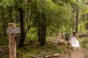 Bride and groom walking the Proxy Falls Trail after their elopement in the Willamette National Forest, PNW Elopement Photographer.