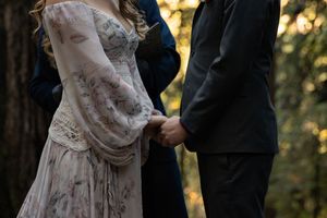 Couple holding hands during their elopement in the California Redwoods during their elopement. PNW elopement photographer.