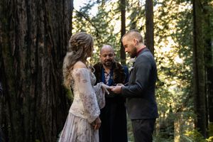 Couple Exchanging rings during their elopement ceremony in the California Redwoods. Adventure Elopement Photographer.