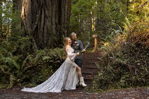 Couple In the California Redwoods Popping Champagne after their Intimate Elopement, Adventure Elopement Photographer.