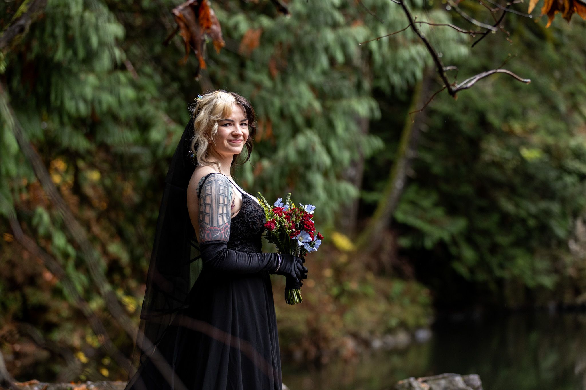 Bride in black dress during her bridal portraits at Mouton Falls. Captured by PNW Elopement Photographer.