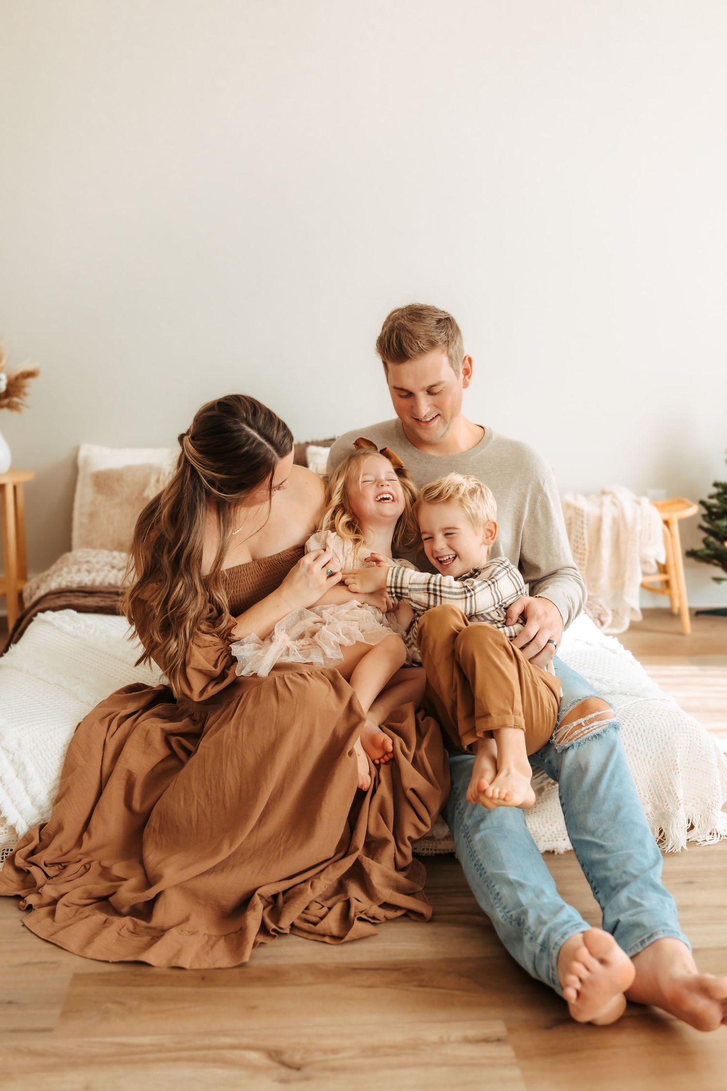 Family of four laughing and snuggled together during a Maryville, TN studio session