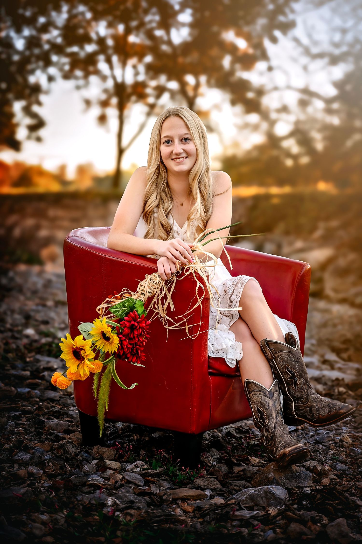 Rustic outdoor photo series featuring a red velvet couch, cowboy boots, and sunflowers at golden hour sunset.
