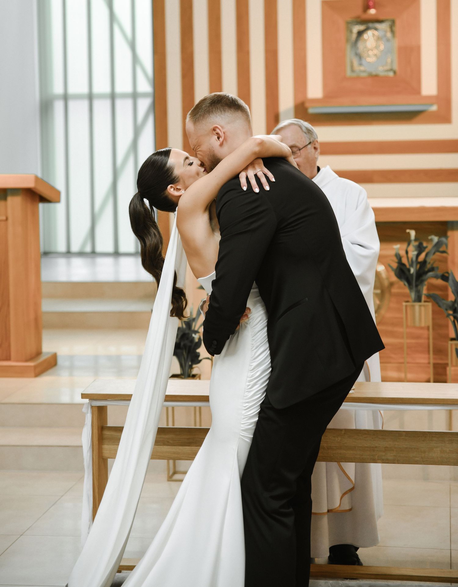 A series of romantic wedding ceremony kisses between a couple in a church setting.